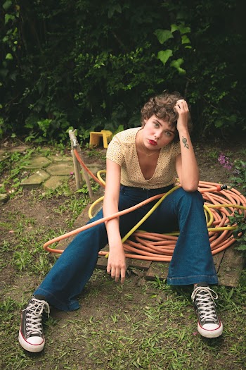 Woman Sitting on Water Hose