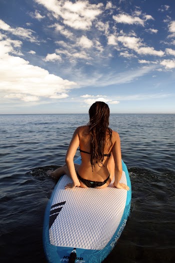 Woman Sitting on White and Blue Surfboard