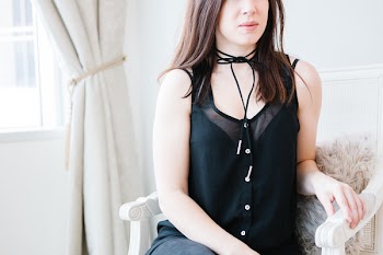Woman Sitting on White Armchair