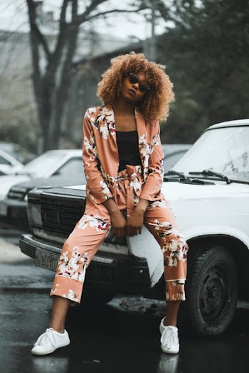 Woman Sitting on White Car Hood