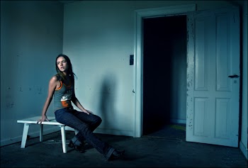 Woman Sitting on White Coffee Table Inside Room