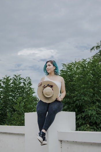 Woman Sitting on White Column