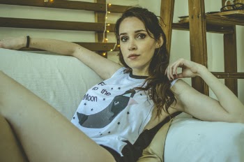 Woman Sitting on White Couch
