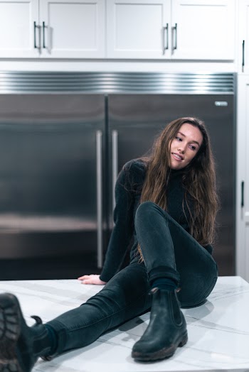 Woman Sitting On White Countertop