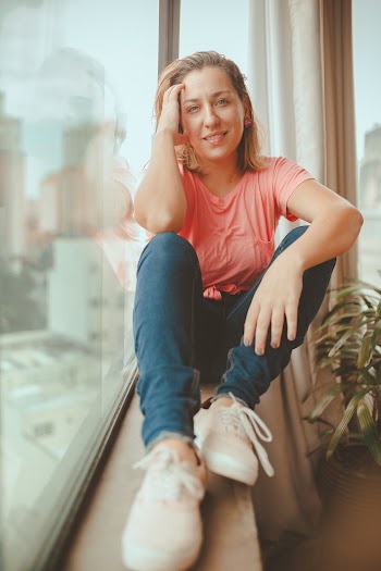 Woman Sitting on Window