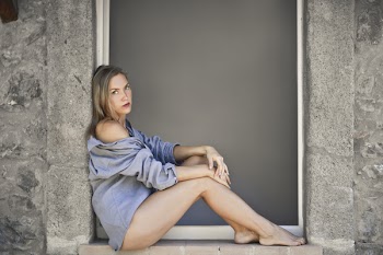 Woman Sitting on Windows Sill