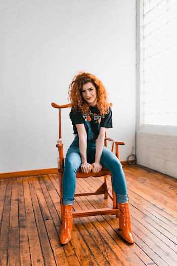 Woman Sitting on Wooden Armchair