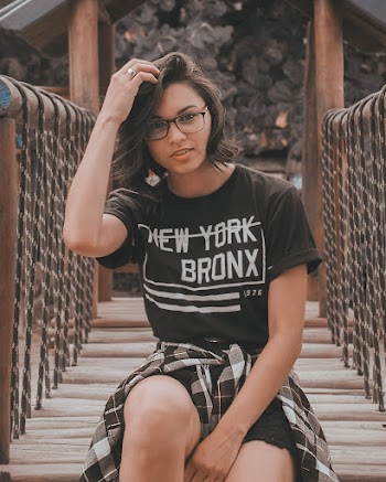 Woman Sitting on Wooden Bridge