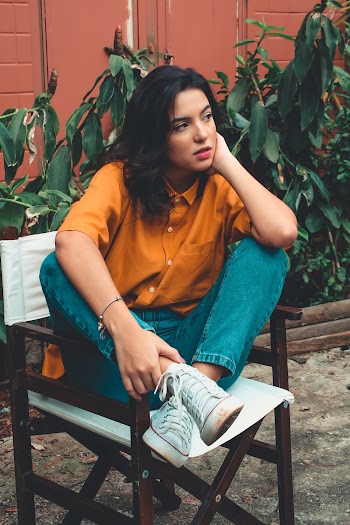 Woman Sitting on Wooden Chair