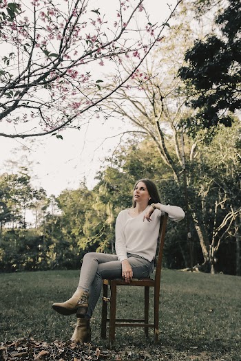 Woman Sitting on Wooden Chair