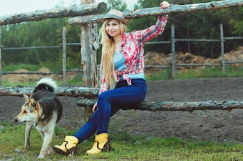 Woman Sitting On Wooden Fence Beside Do