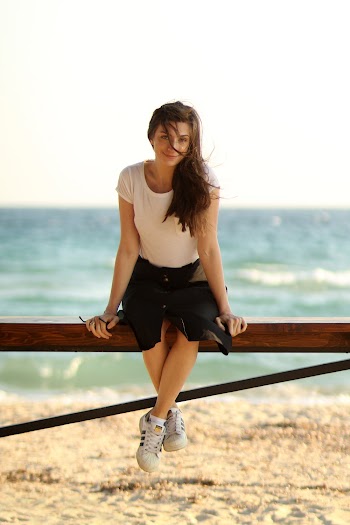 Woman Sitting on Wooden Railings At The Beach