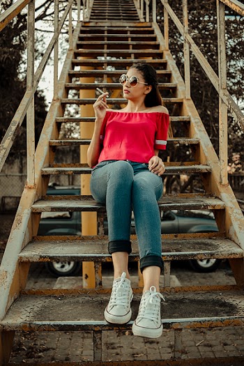Woman Sitting on Yellow and Black Stairway