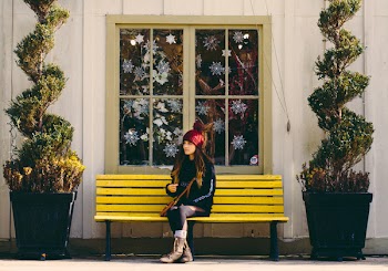 Woman Sitting on Yellow Bench