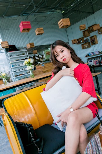 Woman Sitting on Yellow Couch
