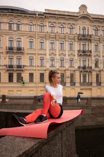 Woman Sitting on Yoga Mat