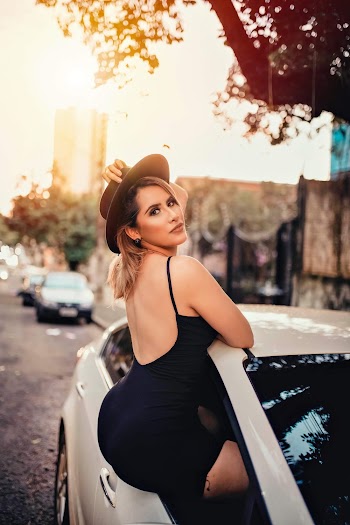 Woman Sitting out a Car Window