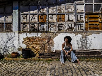 Woman Sitting Outside An Old Building