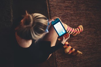 Woman Sitting Playing On Nintendo Switch
