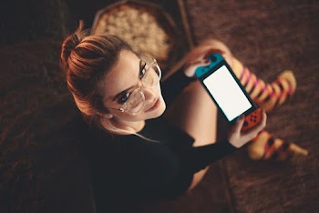 Woman Sitting Playing On Nintendo Switch
