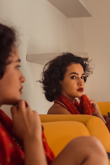 Woman Sitting Sofa Looking at Self in the Mirror