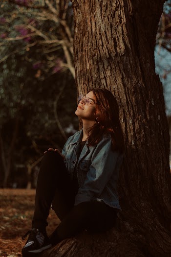 Woman Sitting Under a Tree