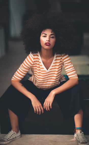 Woman Sitting Wearing Orange And White V-neck Striped Elbow Sleeved Shirt 