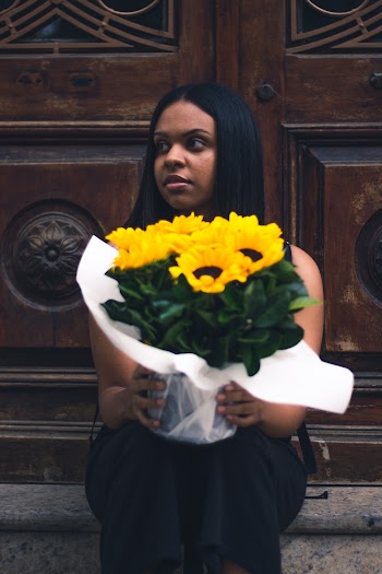 Woman Sitting While Holding Yellow Sunflower Bouquet