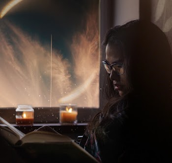 Woman Sitting While Wearing Black Framed Eyeglasses