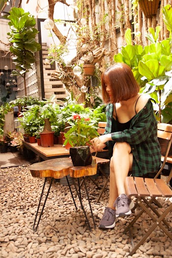 Woman Sitting With Cross Legs Near Table