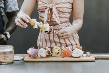 Woman Skewing Vegetables