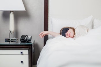 Woman Sleeping In Hotel Room