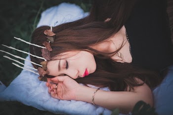 Woman Sleeping on White Comforter