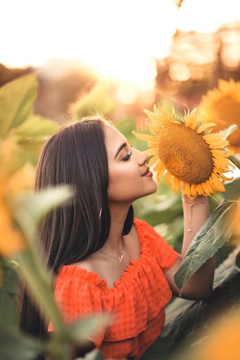 Woman Smelling Sunflower