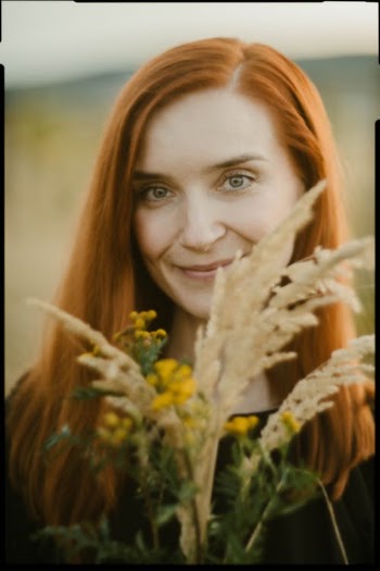 Woman Smiling and Holding Yellow Flowers · Free Stock Photo