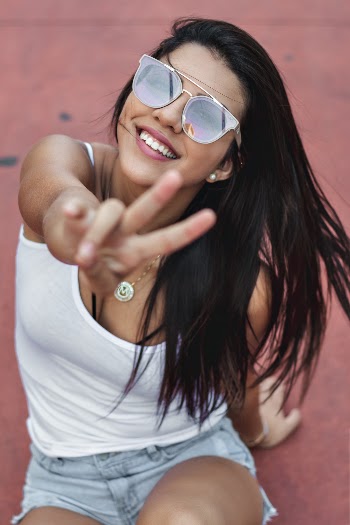 Woman Smiling and Peace Sign