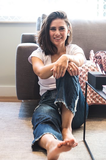 Woman Smiling and Sitting on Floor