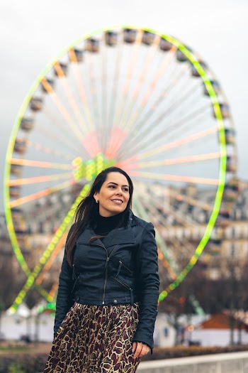 Woman Smiling and Standing Near Ferris Wheel