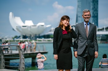 Woman Smiling at Man While Standing Near Marina Bay Sands, Singapore