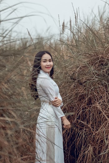 Woman Smiling Beside Bushes