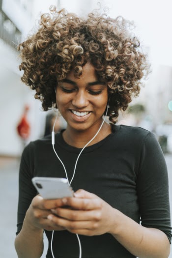 Woman Smiling in Black Crew-neck Long-sleeved Shirt Holding Silver Iphone X