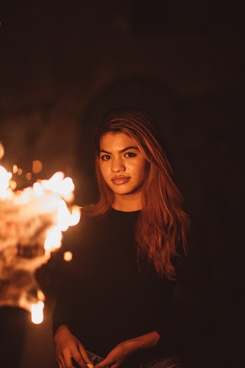 Woman Smiling in Front of Fire