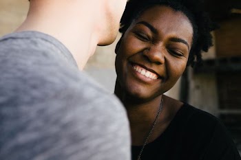 woman smiling in front of man