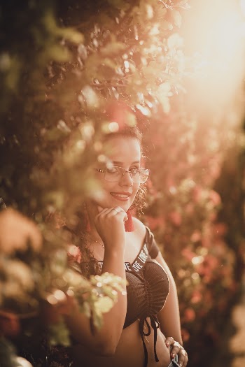 Woman Smiling in Front of Topiary