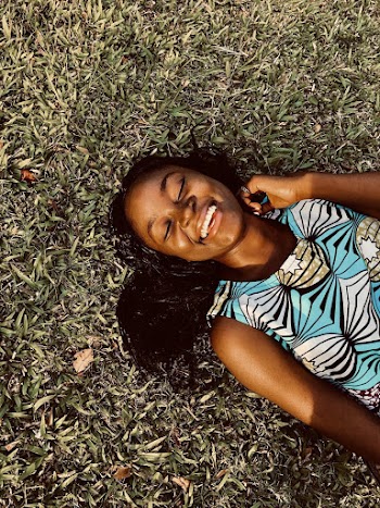 Woman Smiling Lying on Grass