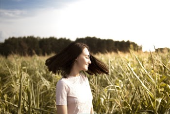 Woman Smiling Near Crop Field