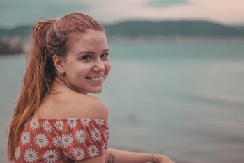 Woman Smiling on Seashore