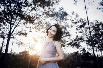Woman Smiling Under Trees