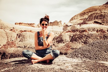 Woman Smiling Wearing Denim Dungarees and Sunglasses