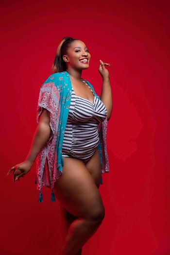 Woman Smiling Wearing White and Black Striped Swimsuit